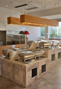 a kitchen with a bunch of pans on a counter at Elounda Orama by GHH in Elounda