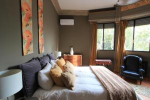 a bedroom with a large bed with pillows on it at -Casa Haydée- in Paysandú