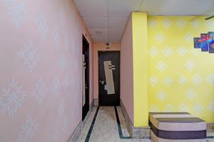 a hallway with snowflakes painted on the wall at FabHotel Relyef Inn in kolkata