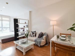 a living room with a couch and a table at Opal in Ban Zong Katiam