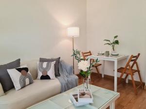 a living room with a couch and a table at Opal in Ban Zong Katiam +15 photos