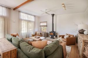 a living room with a couch and a fireplace at Wilyabrup Waters Retreat in Wilyabrup