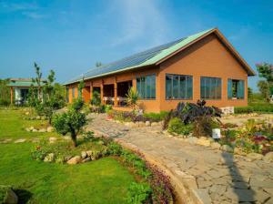 a house with a garden in front of it at ANORA Homestay in Vũng Liêm