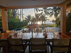 a table in a restaurant with a view of the ocean at Beachfront Pool Villa in Ko Chang
