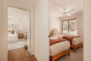 a bedroom with two beds and a window at Wilyabrup Waters Retreat in Wilyabrup