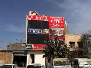 a building with signs on the side of it at SK Hotel Raisingh Nager in Rāisinghnagar