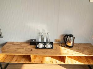 a wooden table with two vases on top of it at ANORA Homestay in Vũng Liêm