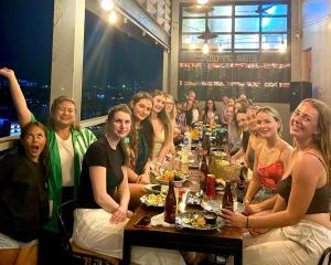 a group of people sitting at a table in a restaurant at Lub d Manila Makati - Central Makati, Near Nightlife in Manila