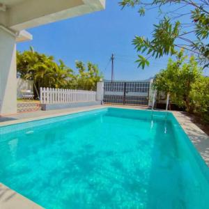 a swimming pool in the backyard of a house at MARIGOLD VILLA Il 3BHK II AC II POOL II in Lonavala