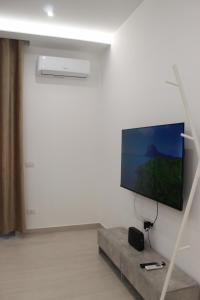 a living room with a flat screen tv on a wall at Casa DieciMare in Torre del Greco +9 photos