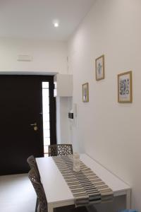 a dining room with a table and two chairs at Casa DieciMare in Torre del Greco