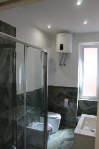 a bathroom with a sink and a toilet at Casa DieciMare in Torre del Greco