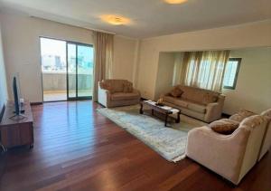 a living room with two couches and a television at Luxury Oasis-May Real Estate Apartments in Addis Ababa