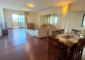 a living room with a dining table and a living room with a couch at Luxury Oasis-May Real Estate Apartments in Addis Ababa