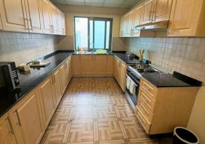 a kitchen with wooden cabinets and a wooden floor at Luxury Oasis-May Real Estate Apartments in Addis Ababa +5 photos
