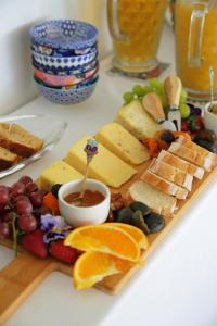 a plate of cheese and fruit on a table at Shalom-self catering apartment in St Francis Bay +4 photos