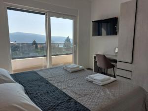 a bedroom with a bed with two towels on it at Holiday house VILLA PATRICK with pool, jacuzzi and sauna in Kornić +41 photos