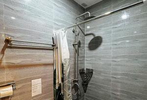 a shower with a glass door in a bathroom at RedDoorz at Balai Malinawon Siargao in General Luna +35 photos