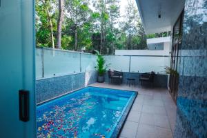 a swimming pool in the middle of a house at DNC Shevaroys Resorts & Spa in Yercaud