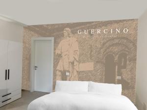 a bedroom with a wall with a mural of a man at Ugo Bassi 98 in Cento +6 photos