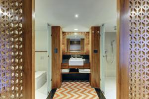 a bathroom with a sink and a tub and a toilet at Cinnamon Bey Beruwala in Bentota