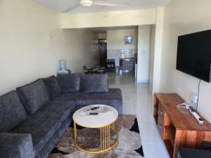 a living room with a couch and a table at Darwin Homes in Mombasa