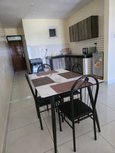 a dining room table and chairs in a kitchen at Darwin Homes in Mombasa