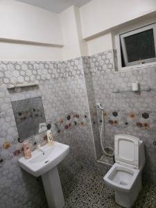 a bathroom with a sink and a toilet at Darwin Homes in Mombasa