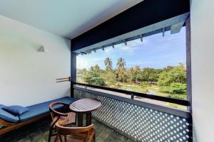 a balcony with a table and chairs and a window at Cinnamon Bey Beruwala in Bentota +134 photos