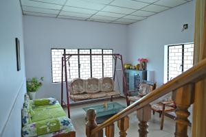 a living room with two chairs and a couch at Giri Darshini Homestay - 3BH, Simple Rooms with Pool & Private Falls in Chikmagalūr +40 photos