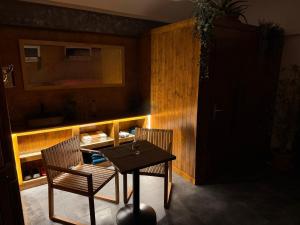 a dining room with a table and two chairs at Bungalovy CLASSIC & Wellness Podhájska - Adults Only in Podhájska