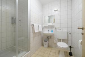 a bathroom with a toilet and a sink and a shower at Haus Mila in Bienenbüttel +53 photos