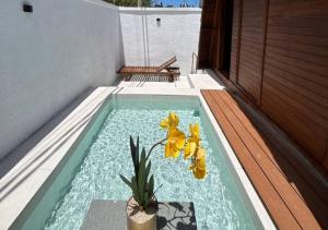 a pool with a plant in the middle of a house at Senara Resort Ciwidey in Baruhtunggul