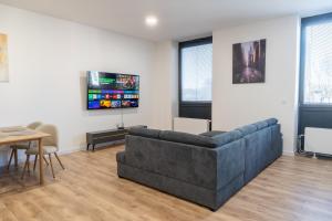 a living room with a couch and a table at Top Apartmán v Central Point Humenné M in Humenné