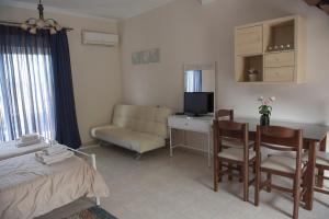 a bedroom with a bed and a desk with a computer at Kalloni Royal Resort in Kalloni