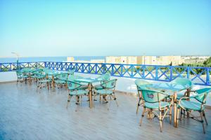 a row of tables and chairs on a balcony at LALA LAND Fayoum in Tunis