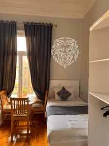 a bedroom with two beds with a lion head on the wall at colombia inn cairo in Cairo