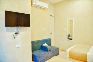 a room with a bed and a tv on a wall at LALA LAND Fayoum in Tunis
