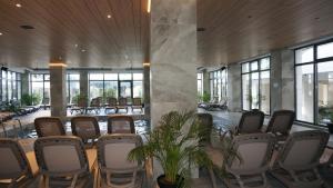 a conference room with chairs and plants in a building at Eleven Odyssey Apartment in Năvodari +99 photos