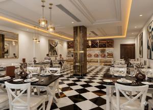 a restaurant with a black and white checkered floor at Qcent Bairagarh Resort Rishikesh in Mohan Chatti