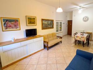 a living room with a couch and a tv at Grottammare mon amour Gigì in Grottammare
