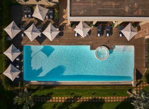 an overhead view of a swimming pool with chairs and a ball at Delaire Graff Lodges and Spa in Stellenbosch