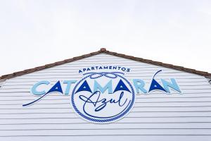 a sign on the side of a building with the words canaan aquarium at Apartamentos Catamarán Azul in Suances