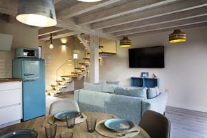 a living room with a couch and a table at Apartamentos Catamarán Azul in Suances