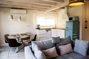 a living room with a couch and a table at Apartamentos Catamarán Azul in Suances