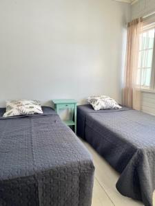 a bedroom with two beds and a window at Vuohensaari, Rantatalo 2 in Salo