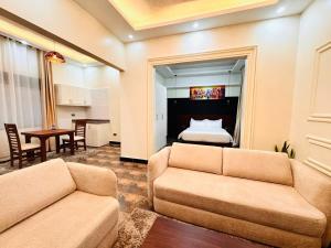 a living room with two couches and a bed at Pieme Hotel Residence in Migade +24 photos
