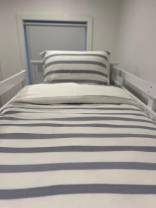 a bed with two pillows on top of it at Saltwater at Warilla Beach in Lake Illawarra +93 photos