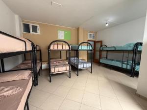 a group of four bunk beds in a room at Exeas Hostel in Vlorë