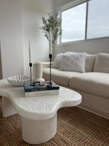 a living room with a table with two candles on it at Saltwater at Warilla Beach in Lake Illawarra